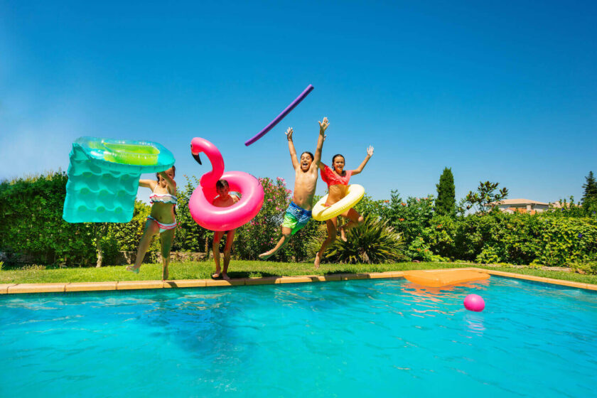 Family jumping into pool